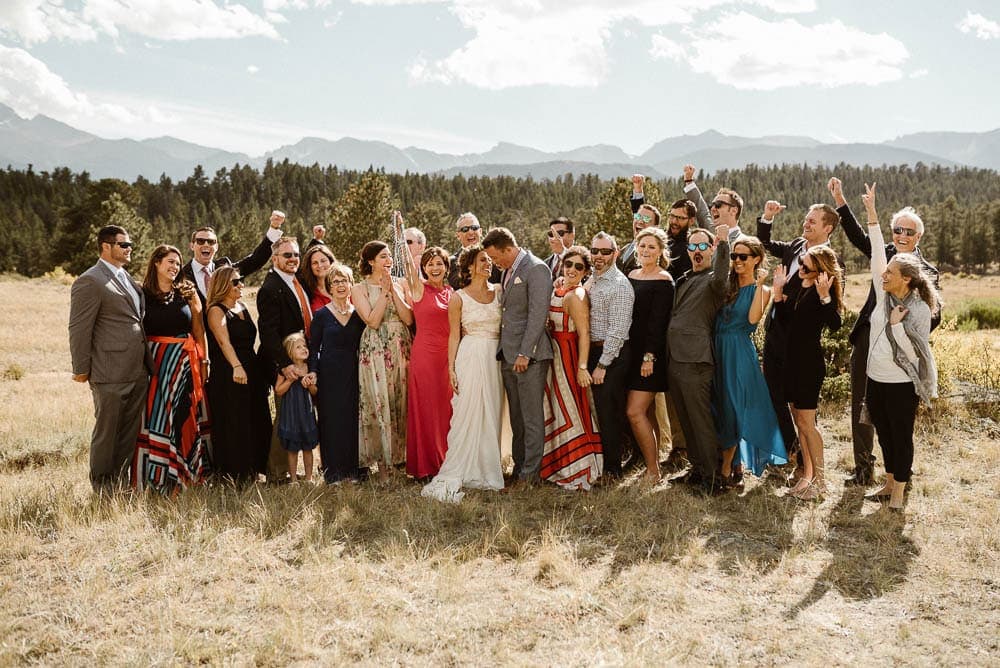 Bride and groom surrounded by their friends and family, on their elopement day, in Rocky Mountain National Park. 