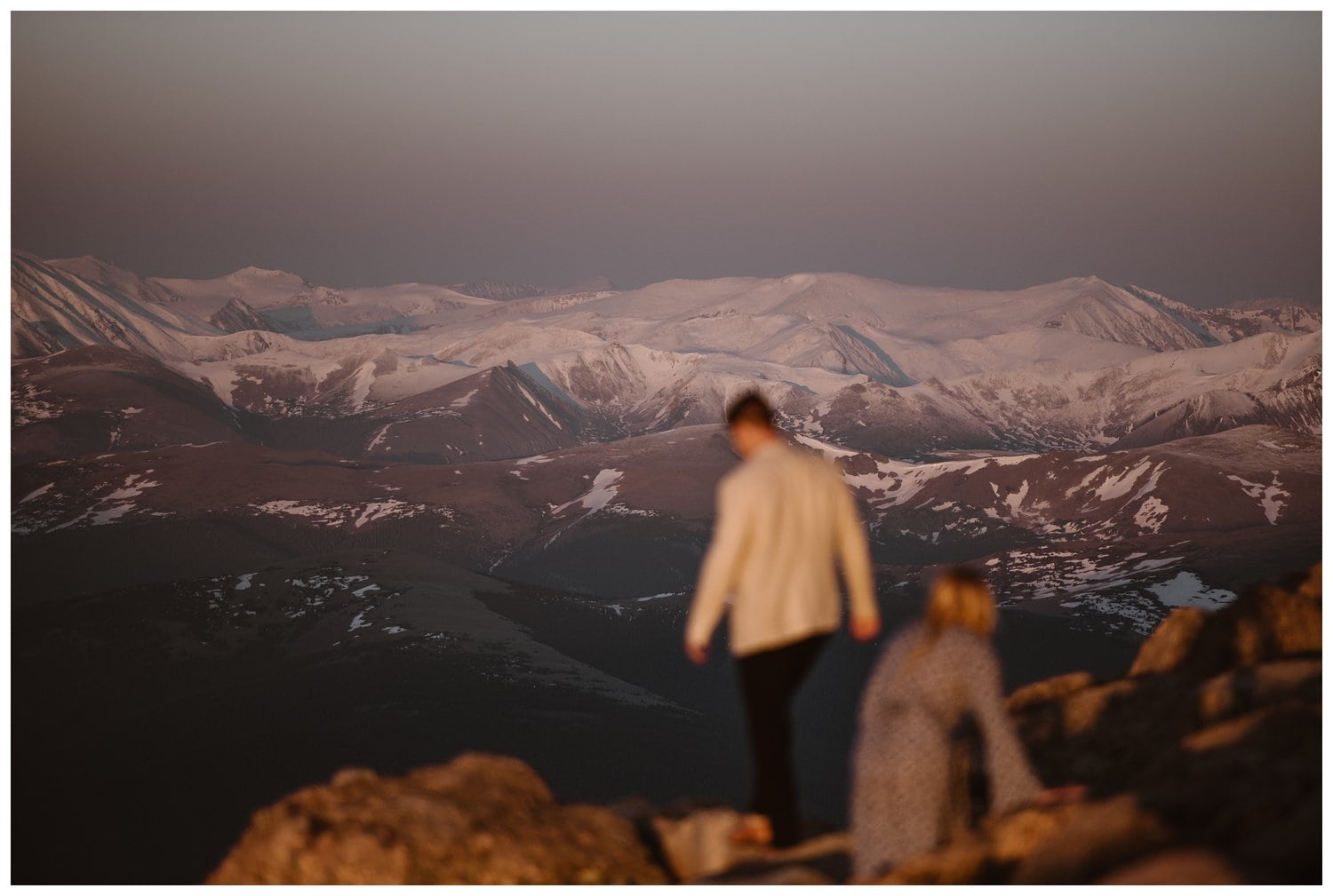 Couple walking around the top of Mt. Evans in Colorado.