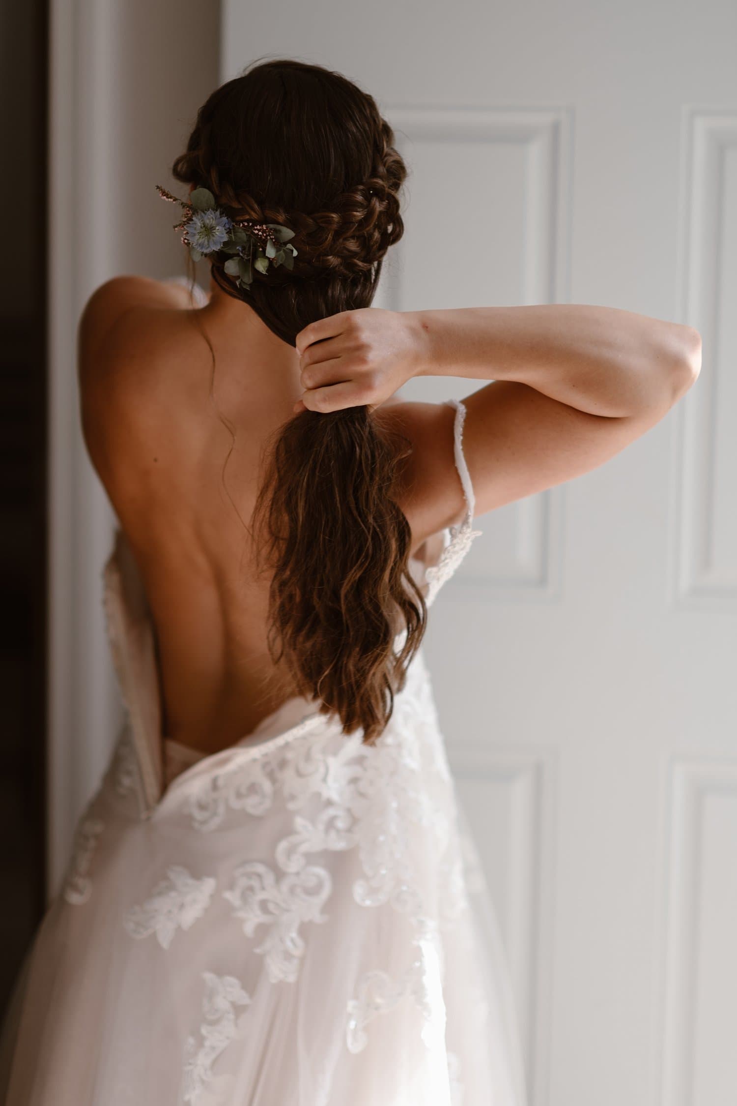 Bride puts on wedding dress in Airbnb. 