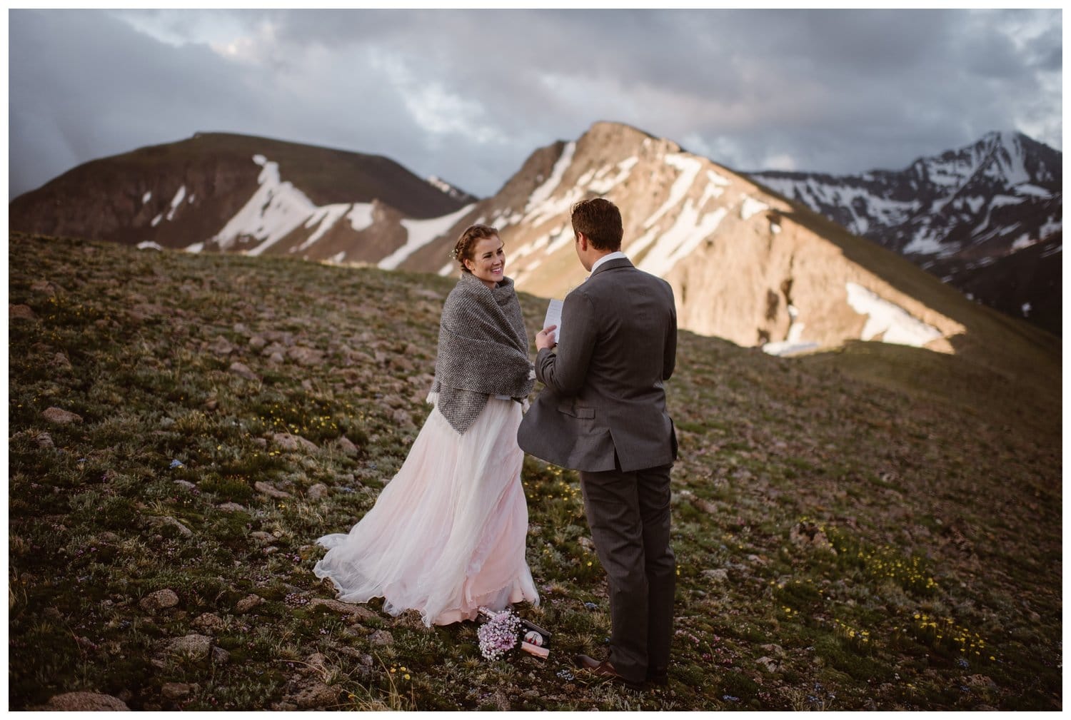 Bride and groom read their vows during a sunrise hiking elopement near Aspen, Colorado. 