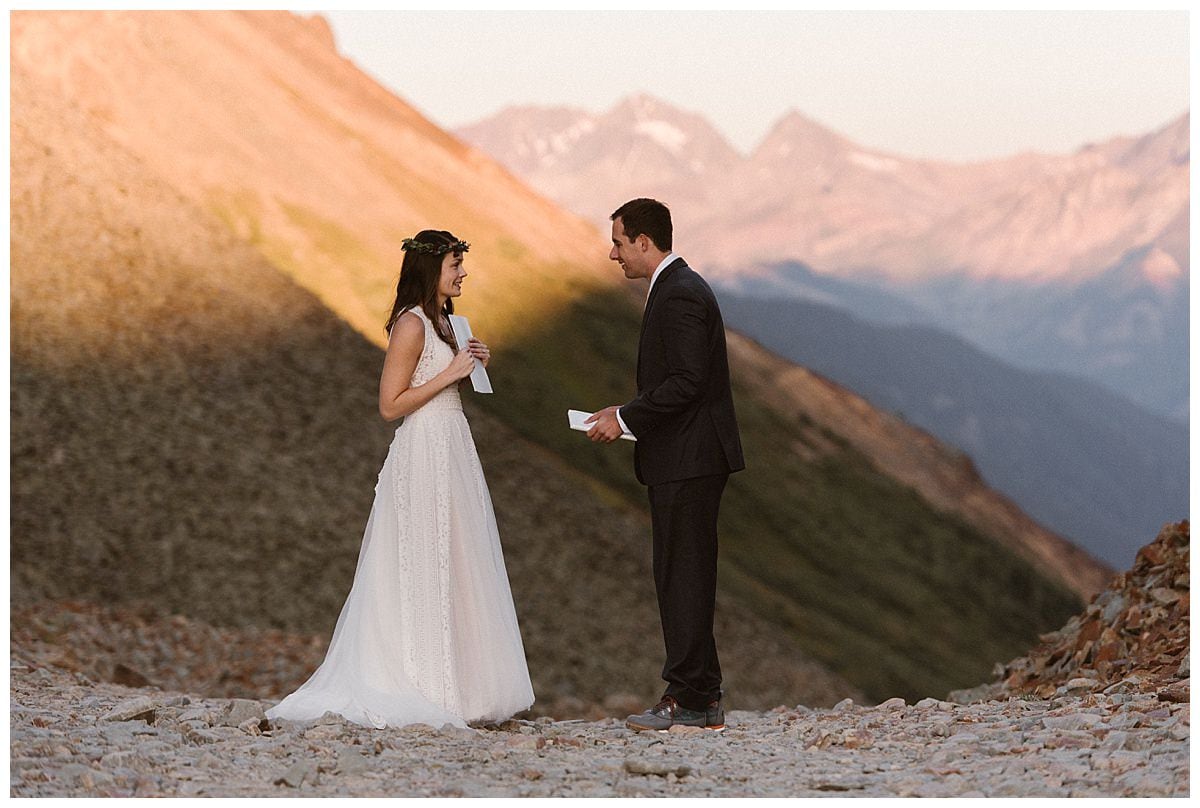 Bride and groom on their elopement day at sunrise at Ophir Pass, in Colorado. 