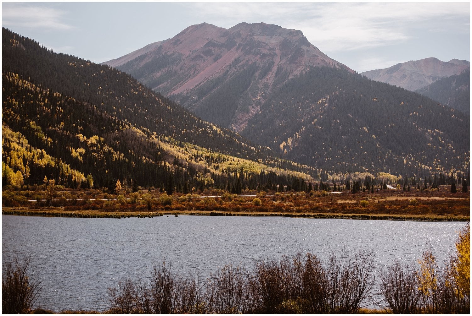 Landscape of mountains and lake with fall colors in Ouray, Colorado. 