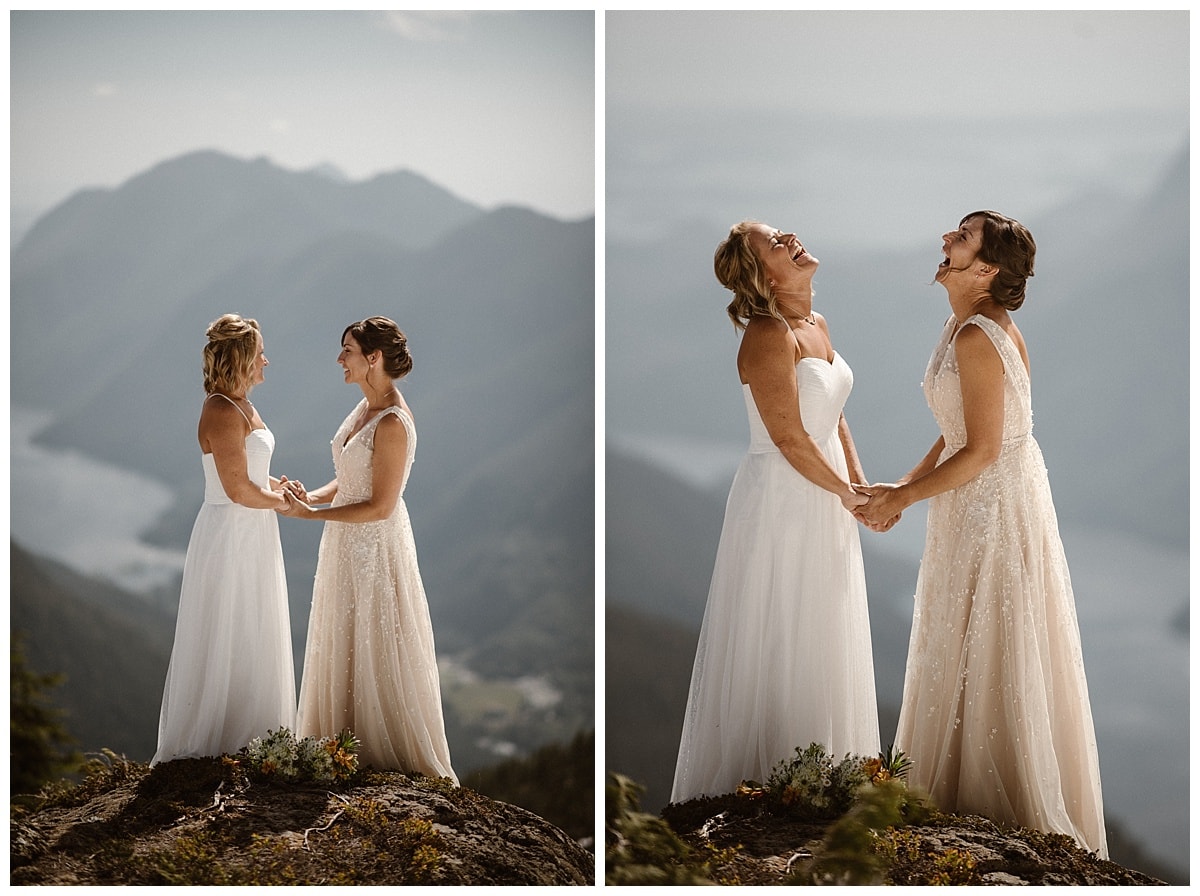 Two brides holding hands and laughing while standing on a cliff in Tofino, Canada. 