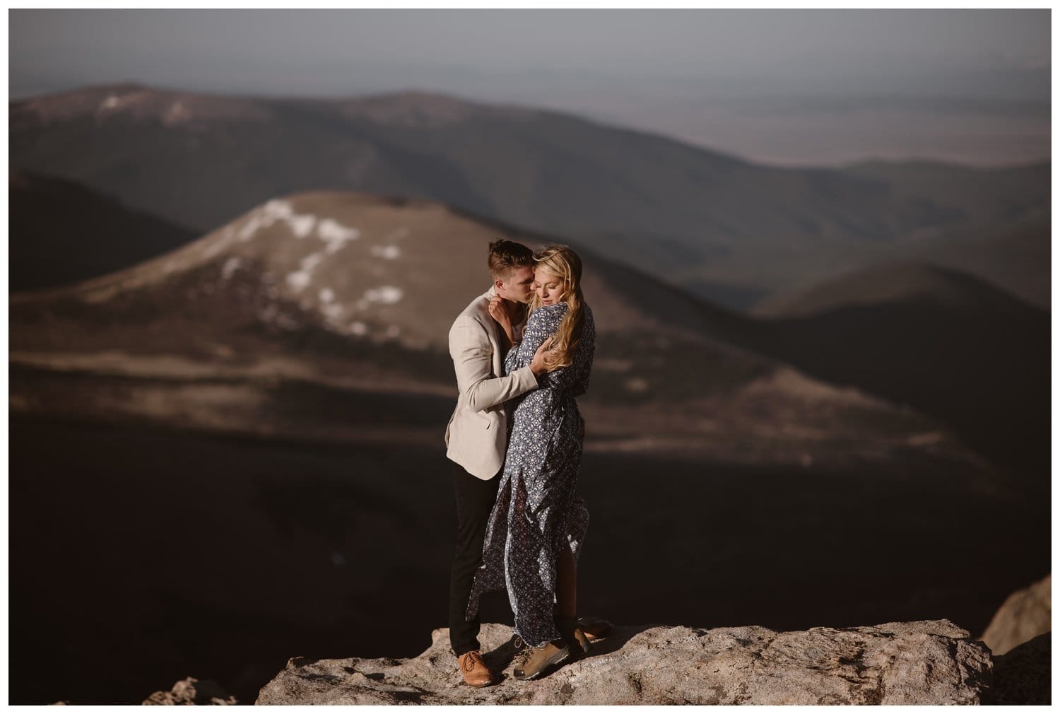 Couple embraces during an engagement shoot at the top of Mt. Evans in Colorado. 