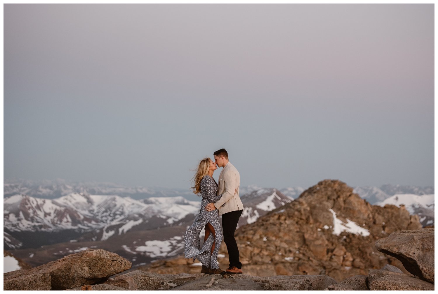 Couple embraces at the top of Mt. Evans in Colorado.