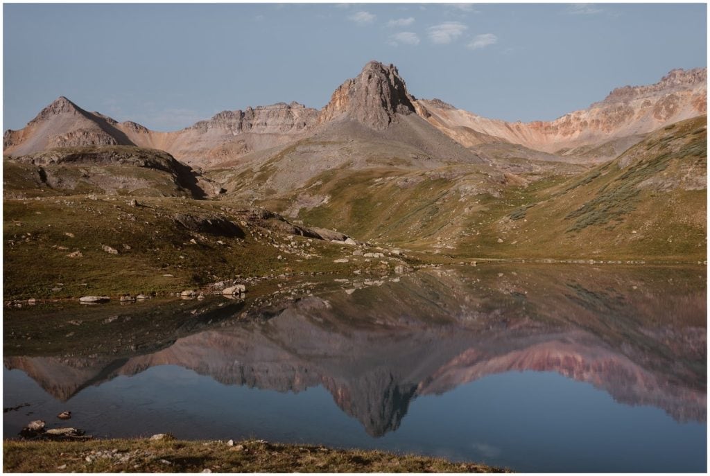 Landscape of mountains reflecting into alpine lake. 