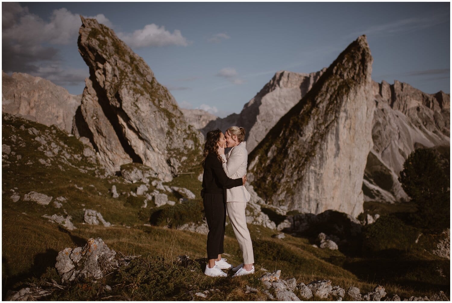 Two brides kiss in the Italian Dolomites. 