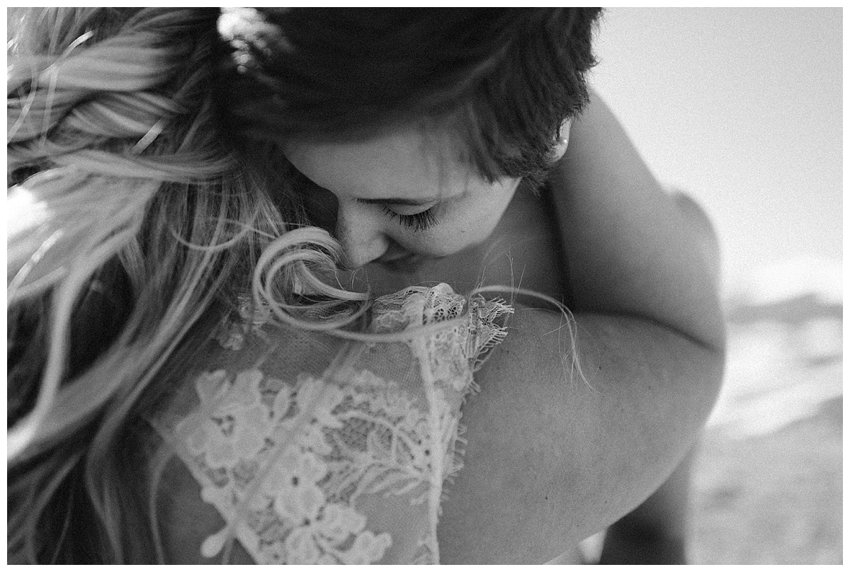Close-up of brides hugging in black and white. 
