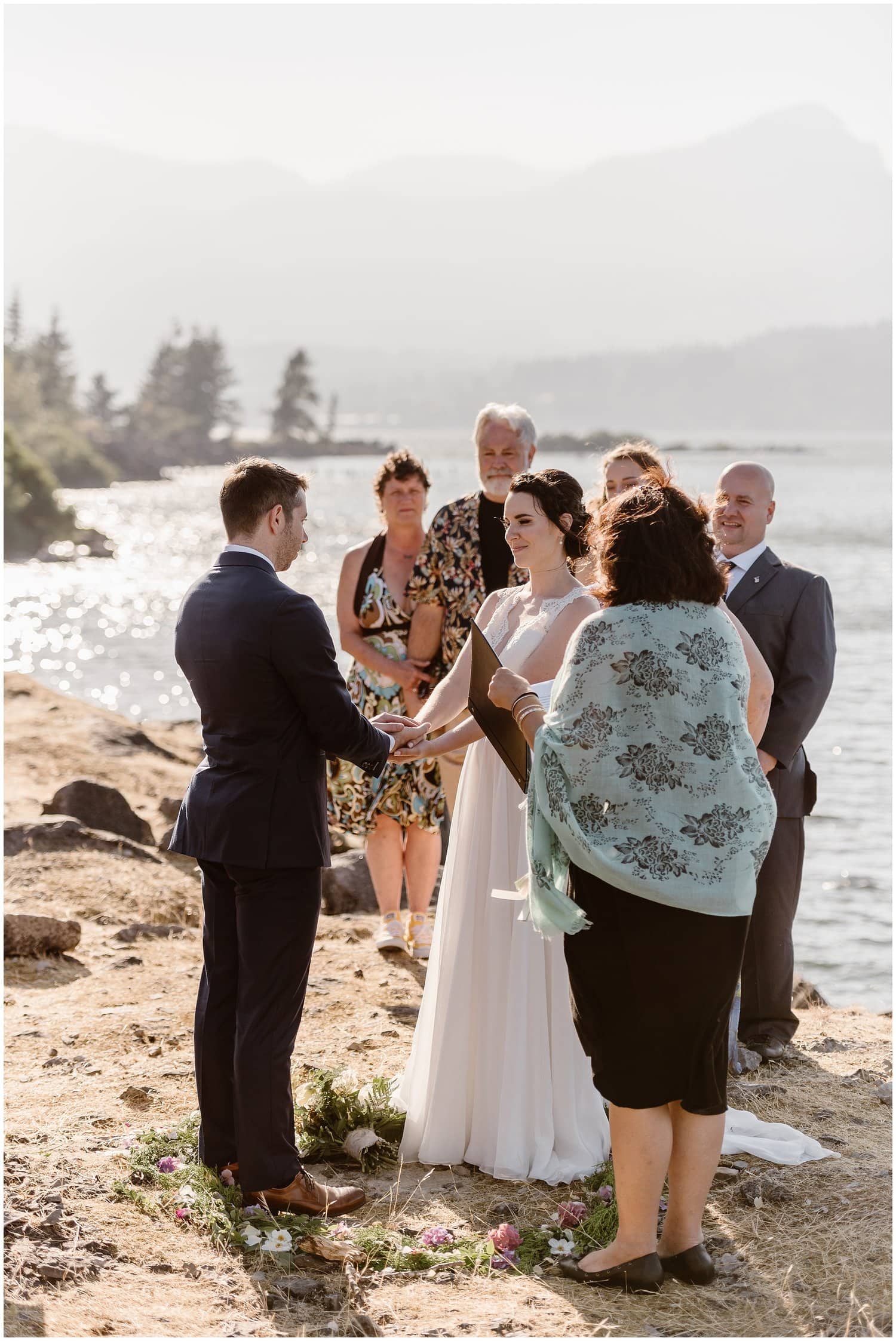 Bride and groom surrounded by friends and family during their intimate elopement ceremony at the Columbia River Gorge in Oregon. 