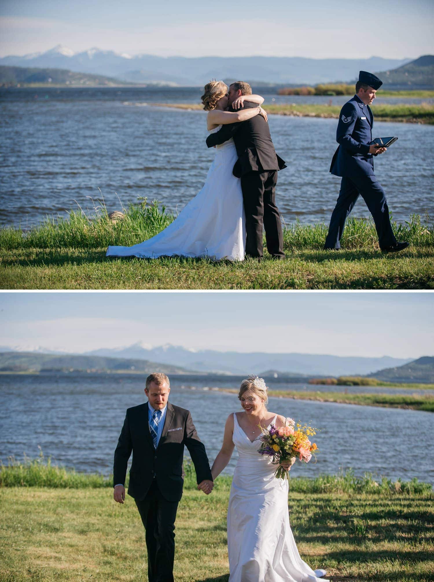 Bride and groom share a kiss during their intimate elopement ceremony in Grand Lake, Colorado. There is a lake and mountains in the background. 