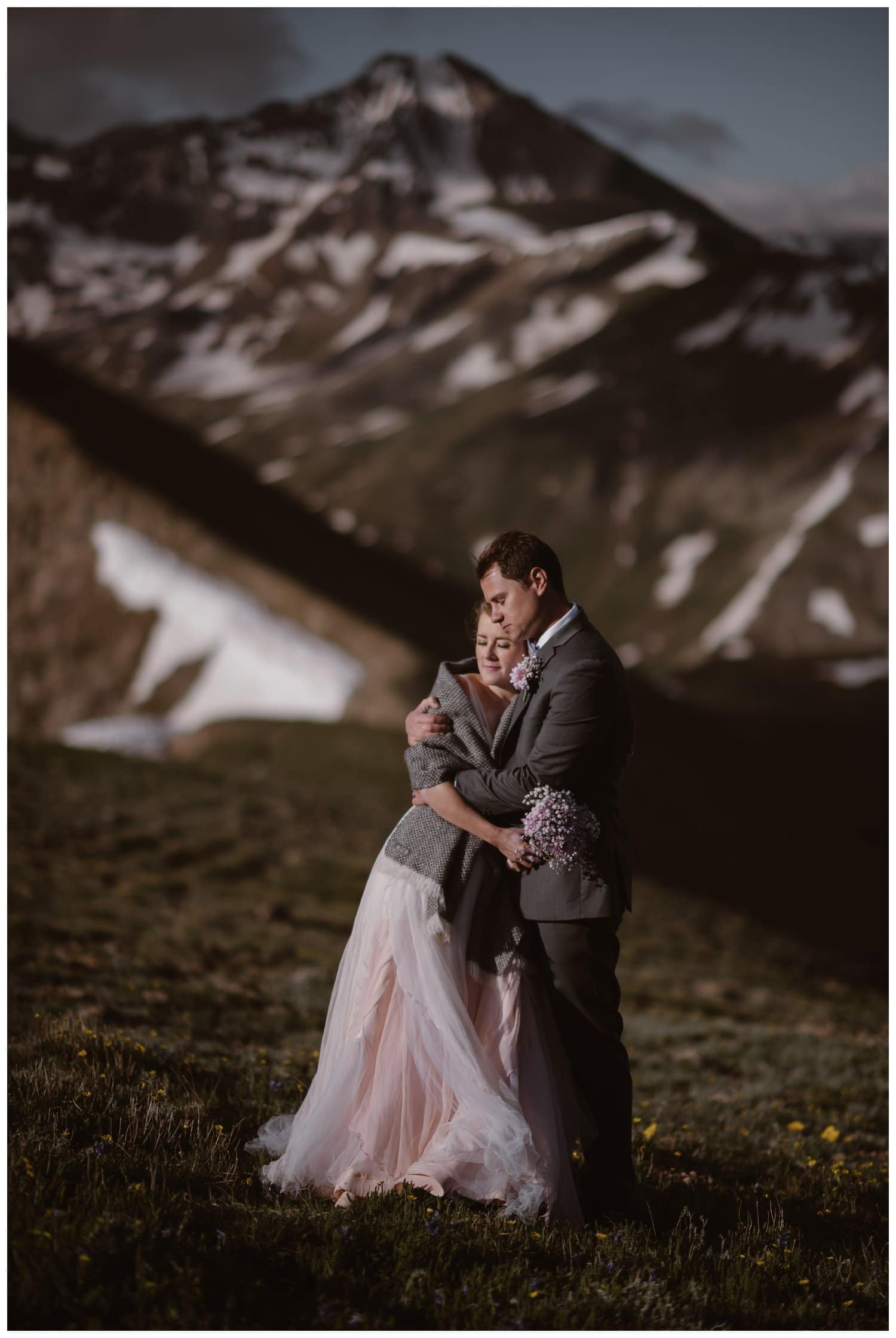 Bride and groom embrace during a sunrise hiking elopement near Aspen, Colorado. 