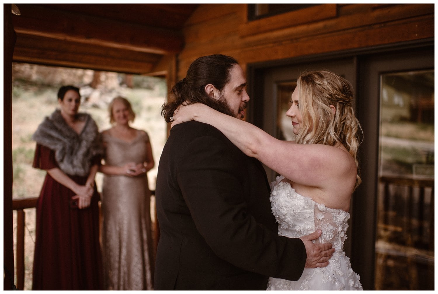 Bride and groom share a first dance on the deck of cabin in Estes Park, Colorado. 