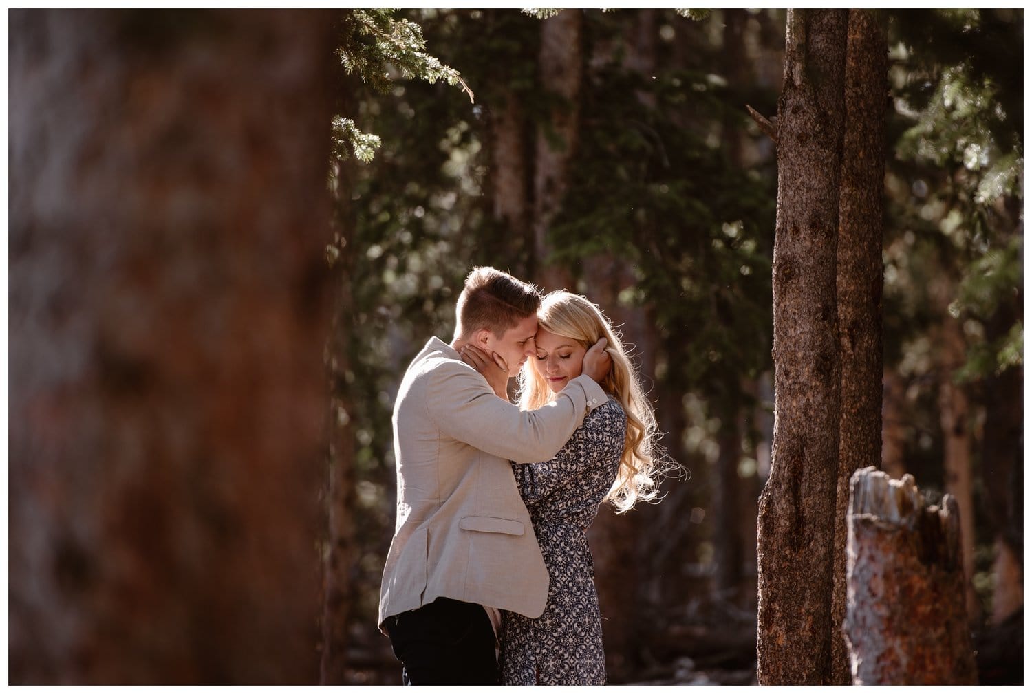 Couple embraces in a forest near Mt. Evans in Colorado. 