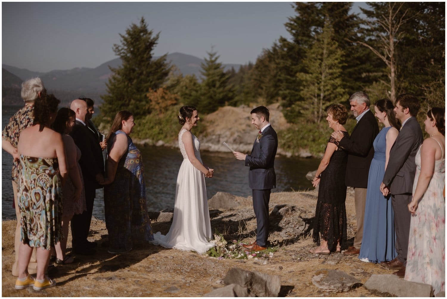 Groom reads his vows to the bride during their intimate elopement ceremony at the Columbia River Gorge in Oregon. They are surrounded by friends and family. 