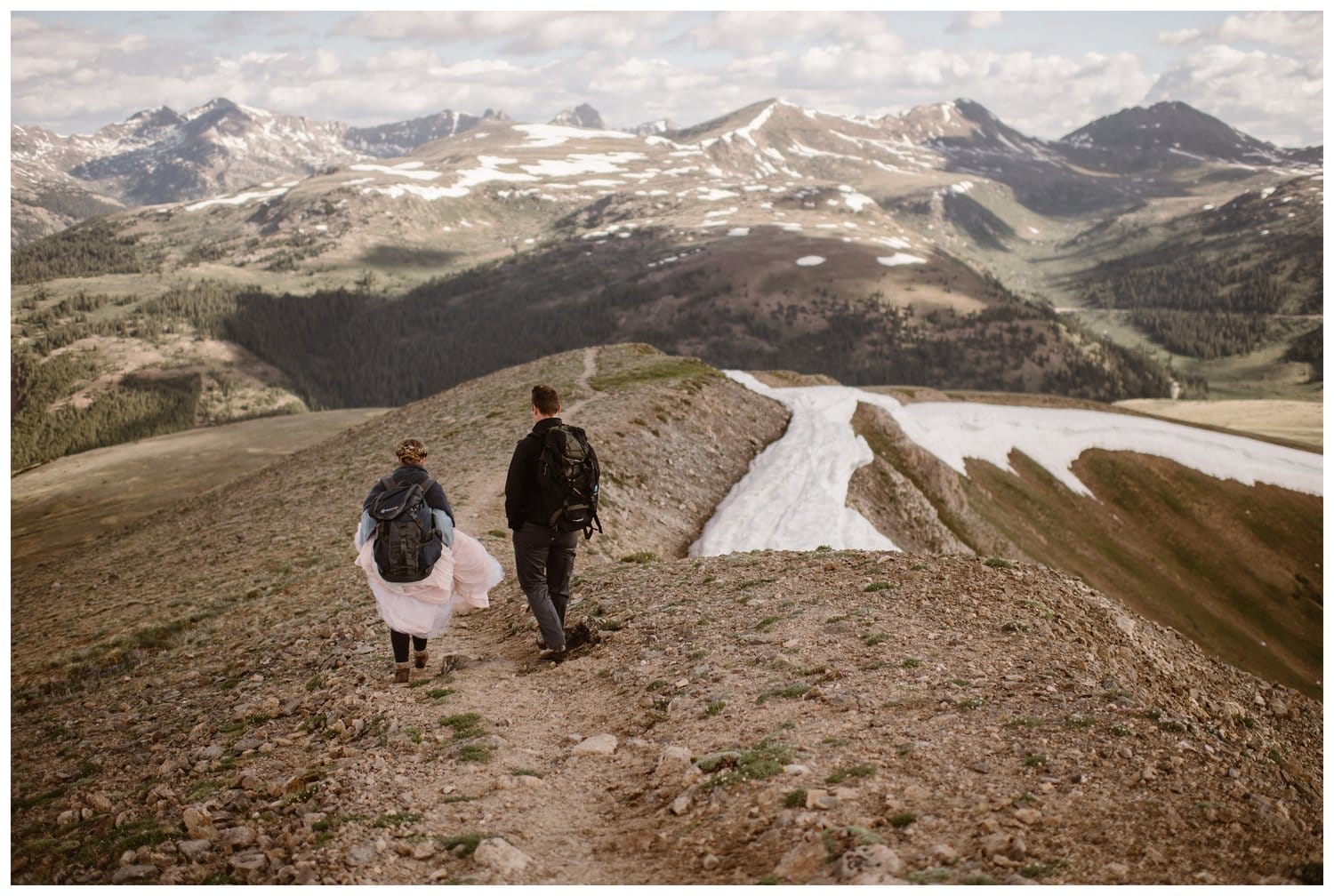 Bride and groom hike along mountain ridge during a sunrise hiking elopement near Aspen, Colorado. 