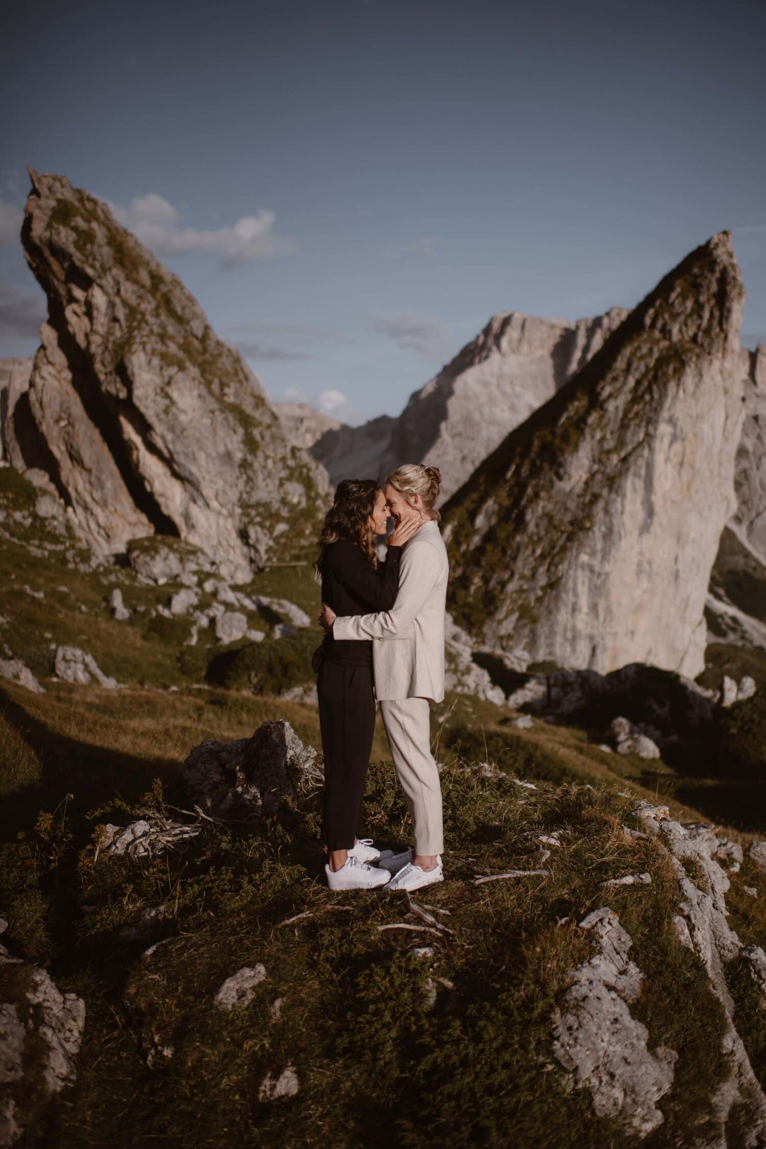 Two brides kissing in the Italian Dolomites.