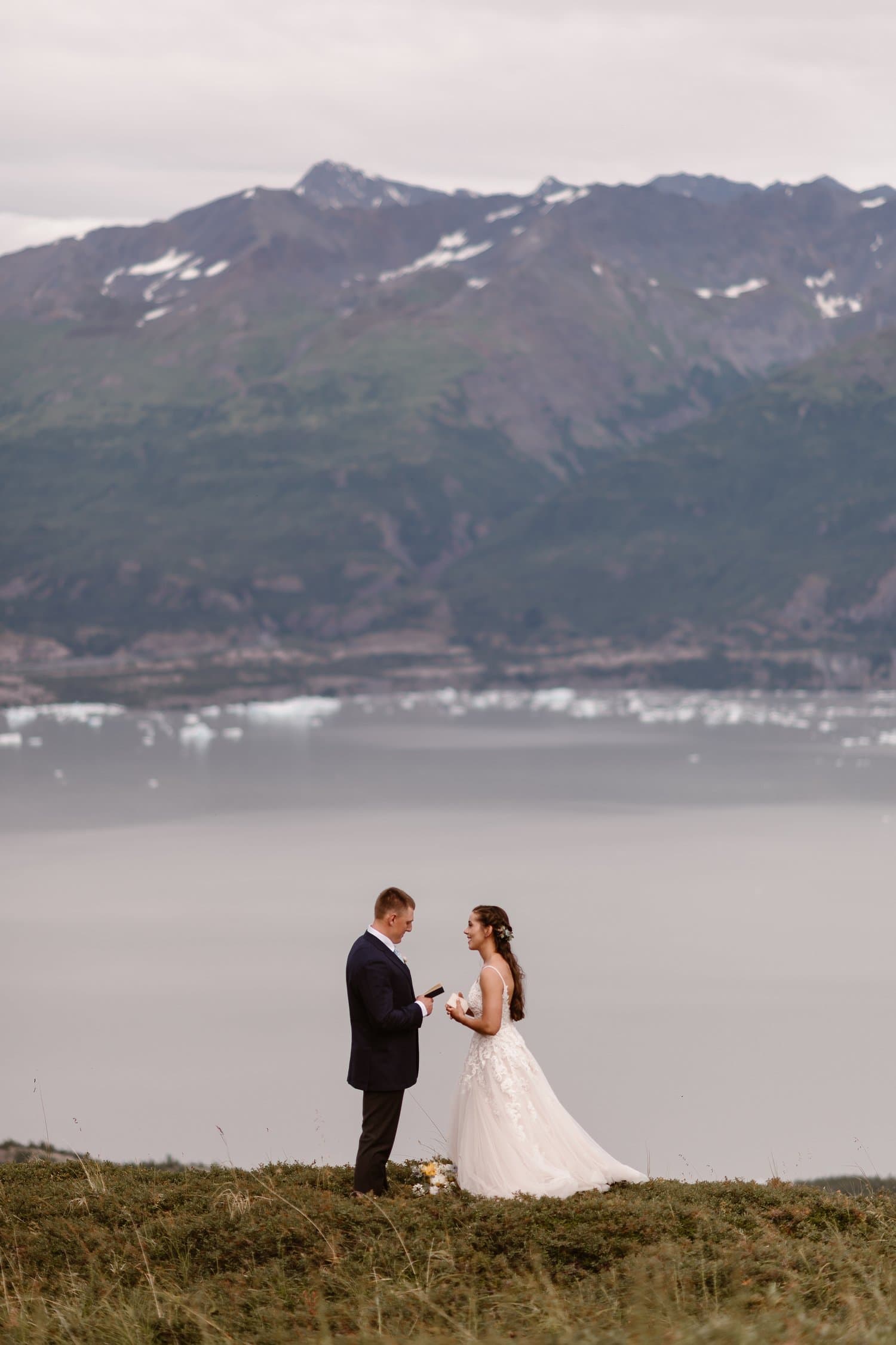 Bride and groom share their vows in front of a glacial lake in Alaska. 