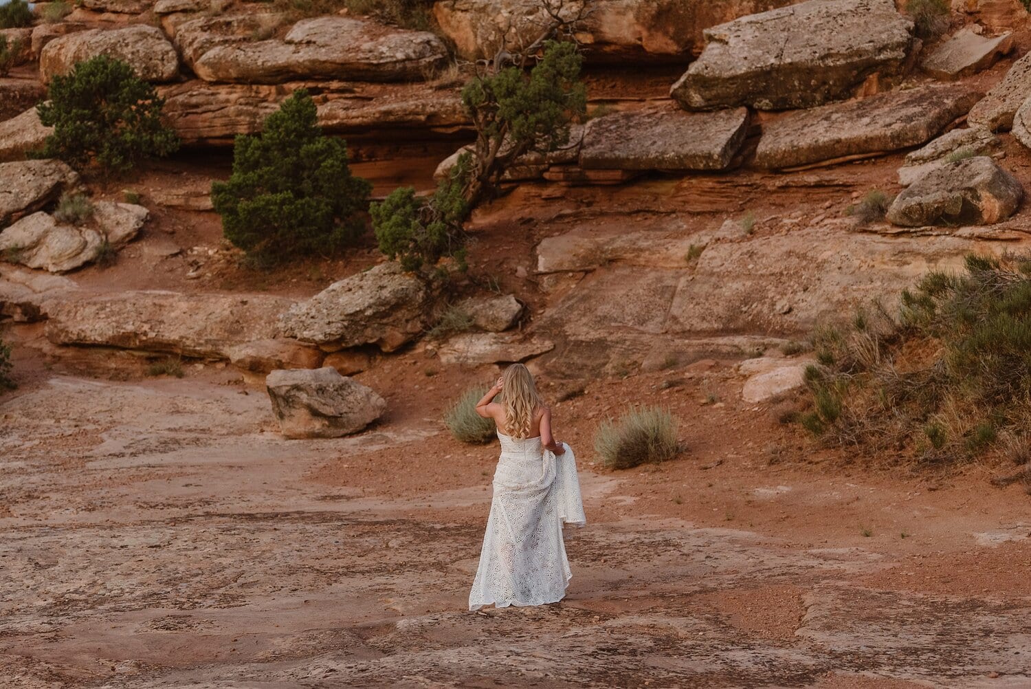 Bride looking at landscape at Colorado National Monument. 