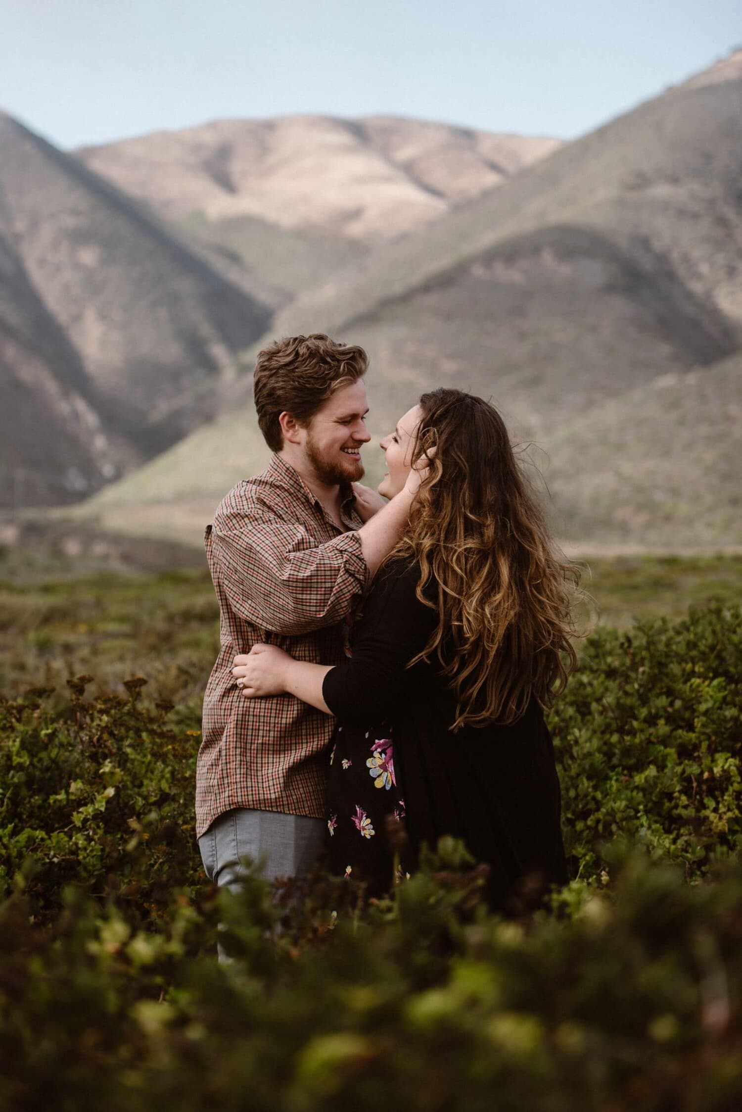 Bride and groom embrace and smile at each other on their elopement day in Big Sur, California.