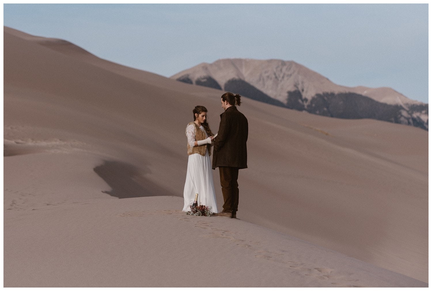 Bride and groom read their vows at Great Sand Dunes National Park.
