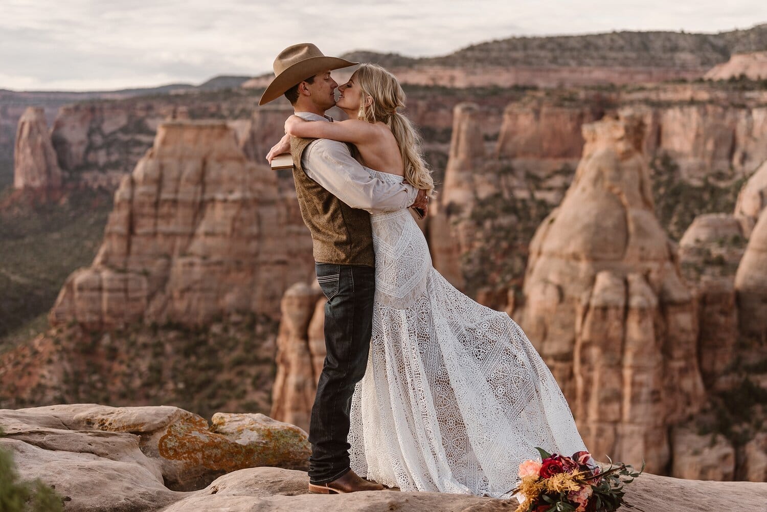 Bride and groom hug after reading  their vows during desert adventure elopement at Colorado National Monument. 