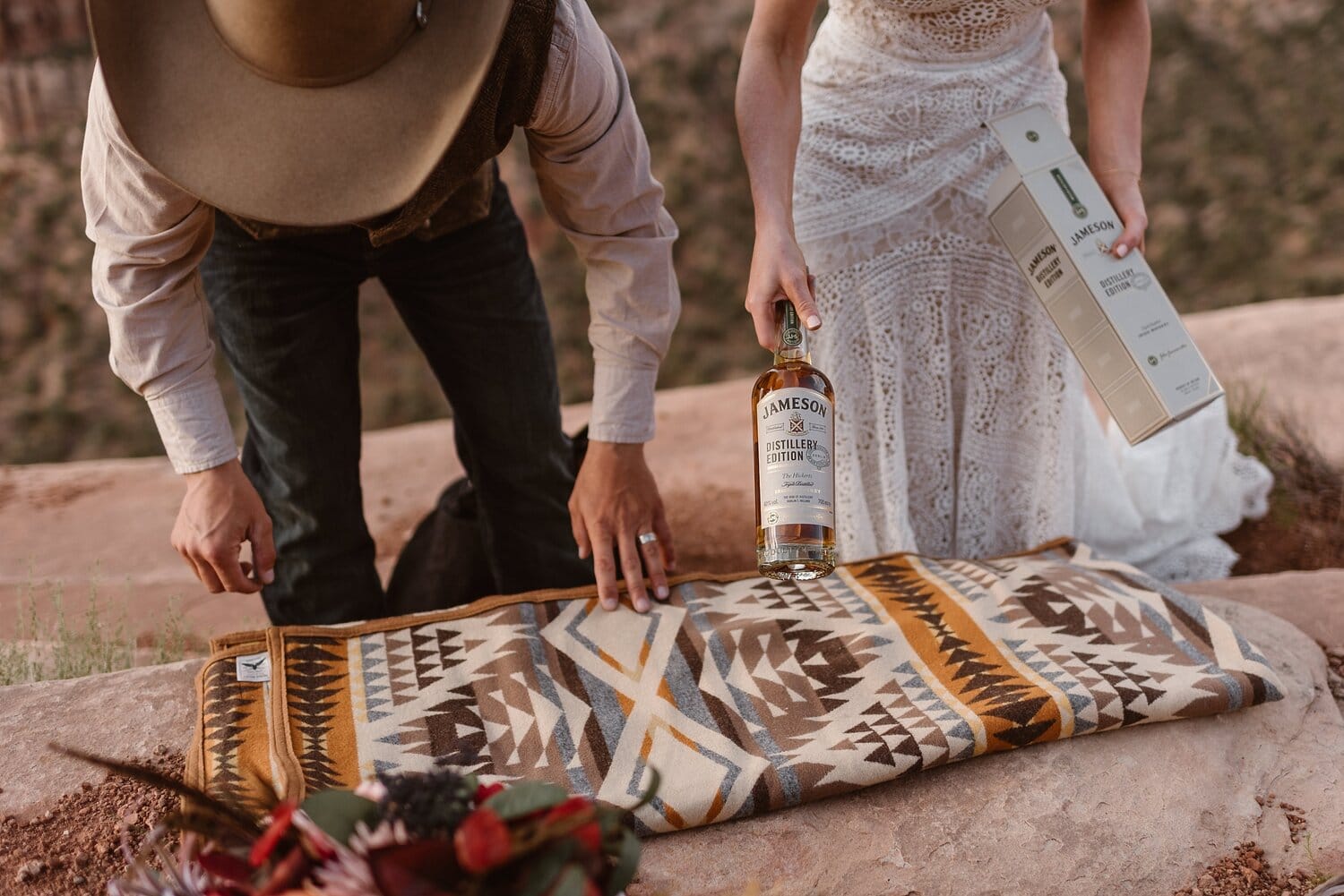 Bride and groom set up picnic at Colorado National Monument. 