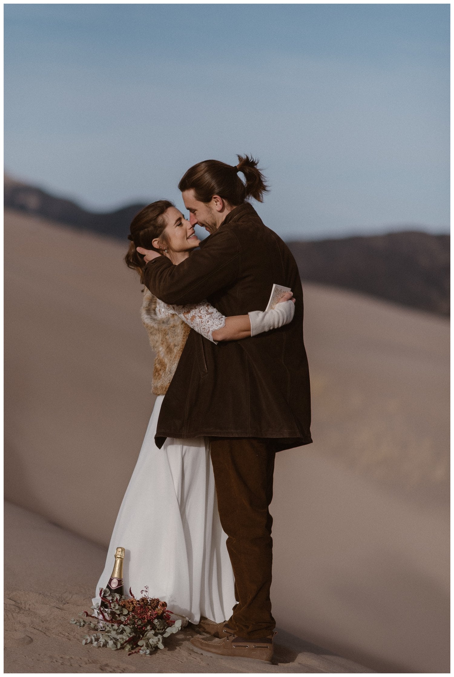 Bride and groom embrace at Great Sand Dunes National Park.