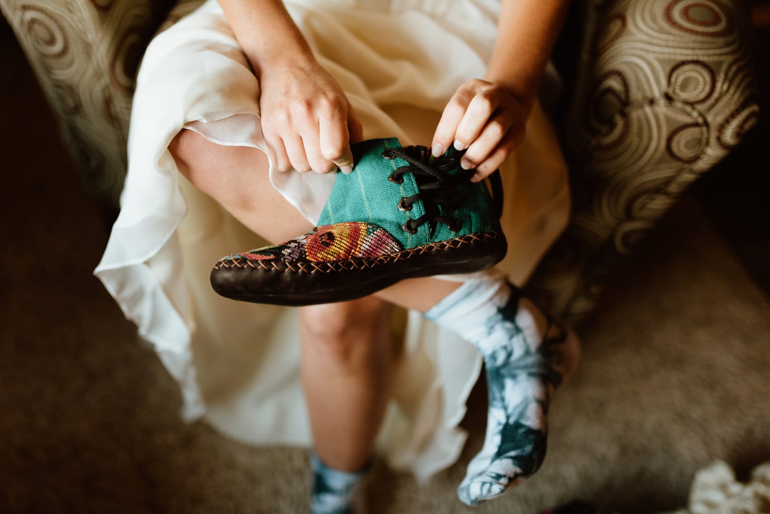 Bride puts on her shoes on her elopement day in Colorado.