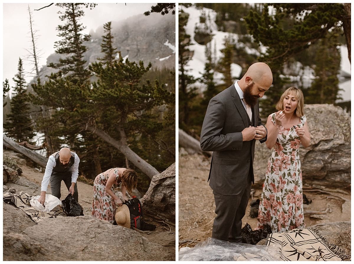 Bride and groom getting ready together in Rocky Mountain National Park. Bride is wearing a white and peach colored floral dress. Groom is wearing a dark grey suit, with a peach colored tie. 