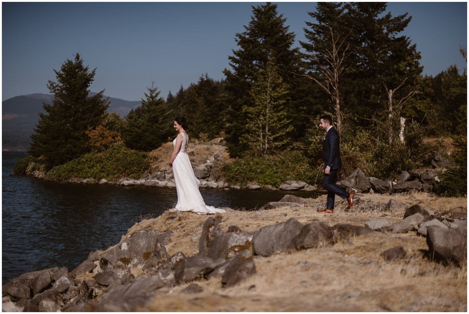 Groom approaches bride for a first look at the Columbia River Gorge, in Oregon. 