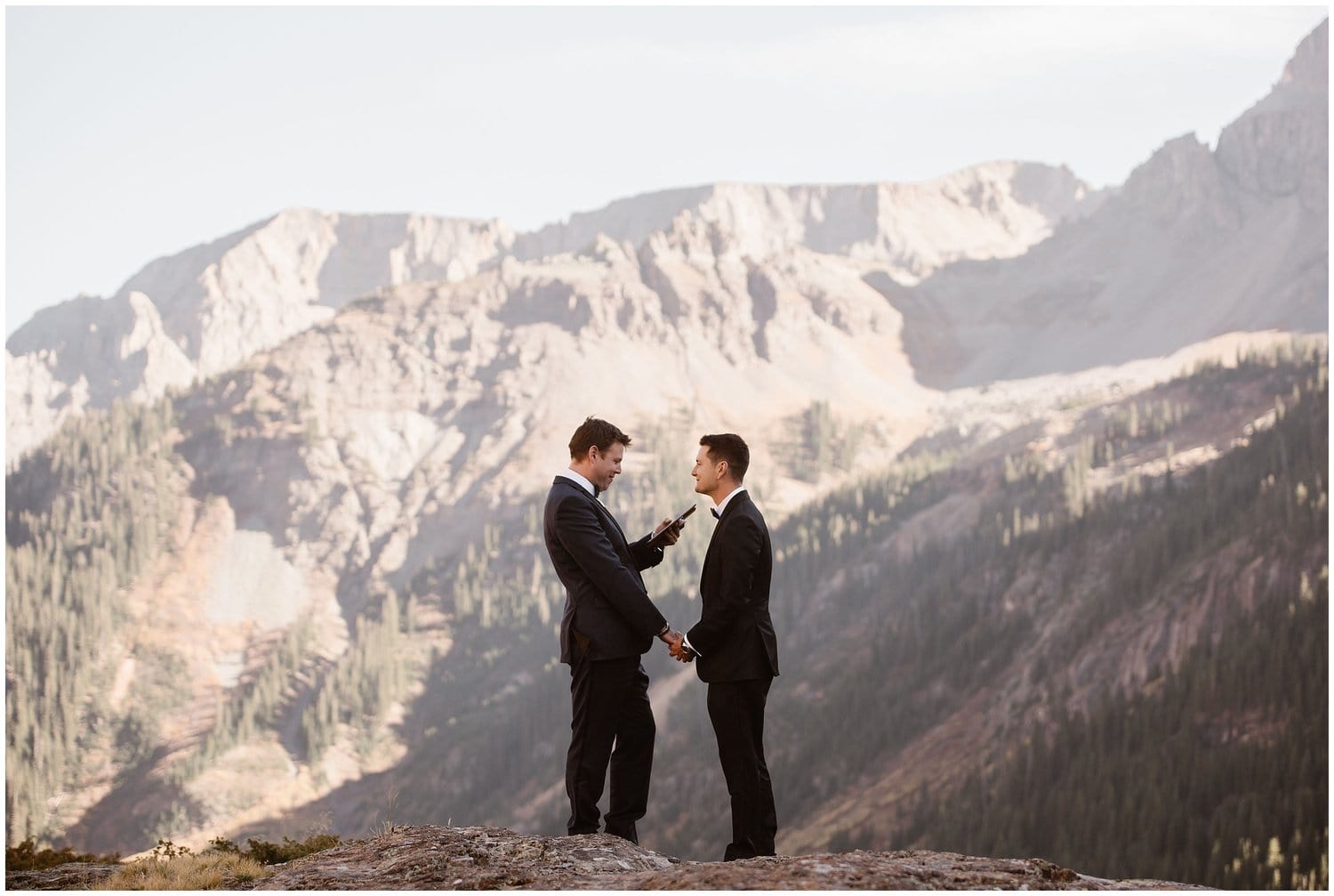 Grooms read their vows with mountains in the background in Ouray, Colorado. 