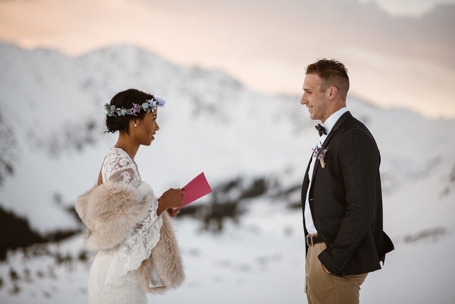 Bride and groom exchange vows during an intimate elopement ceremony at Loveland Pass, in Colorado. 
