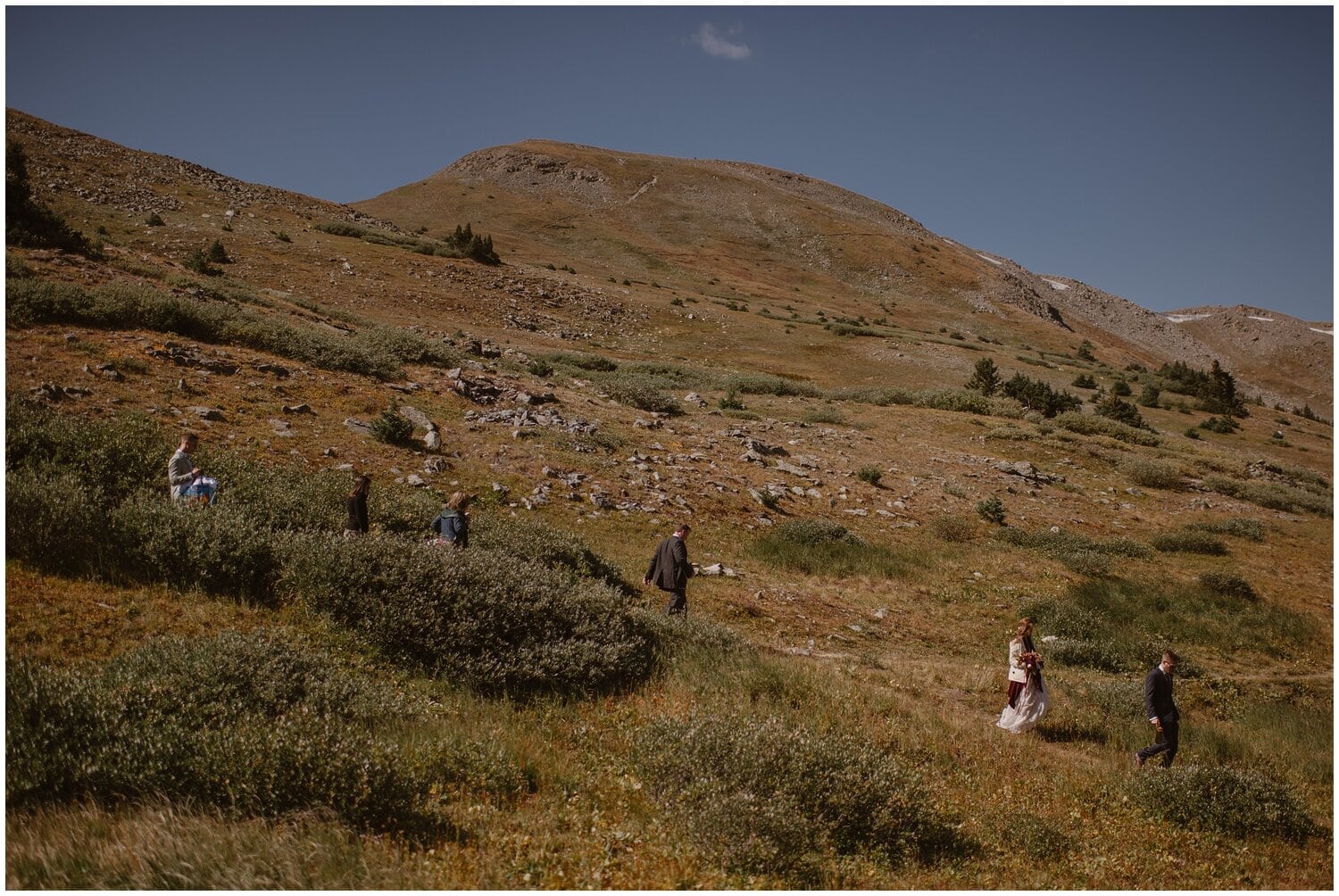 Bride and groom's families hiking on trail in Buena Vista, Colorado. 