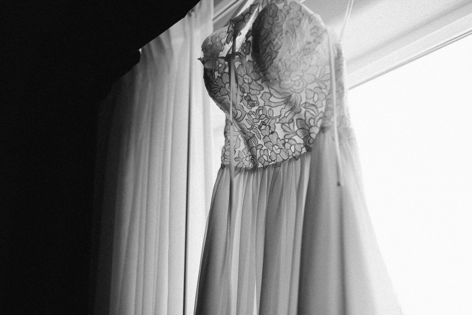 Black and white close up of wedding dress. 