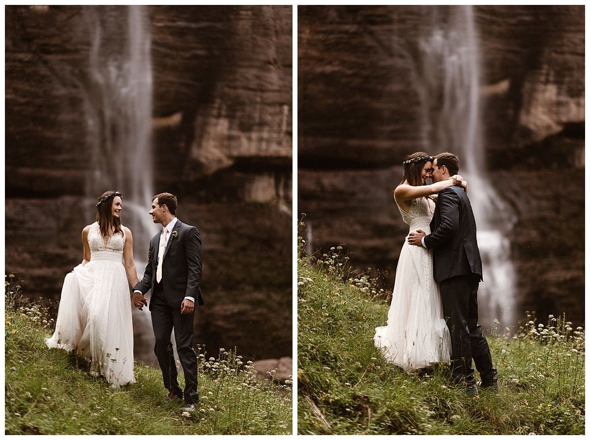 Bride and groom embrace in front of waterfall at Bridal Veil Falls in Telluride, Colorado. 