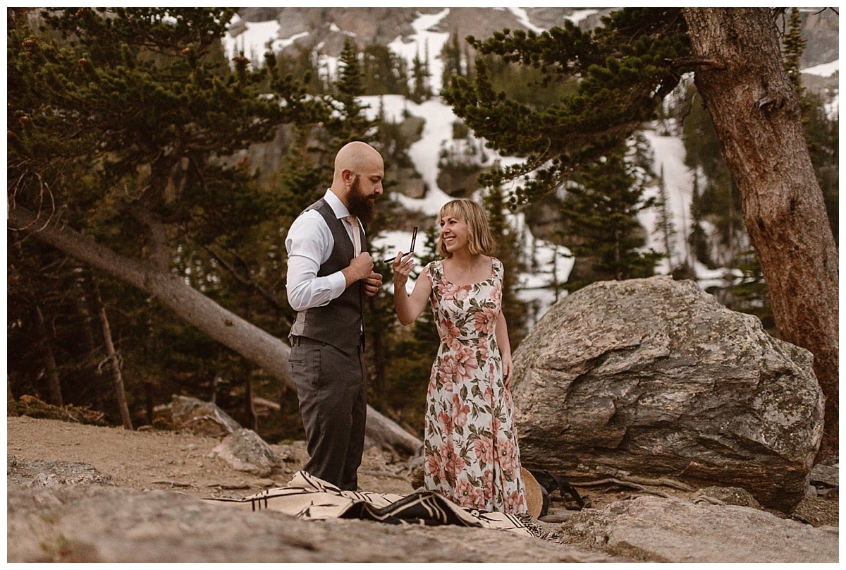 Bride and groom getting ready together in Rocky Mountain National Park. 
