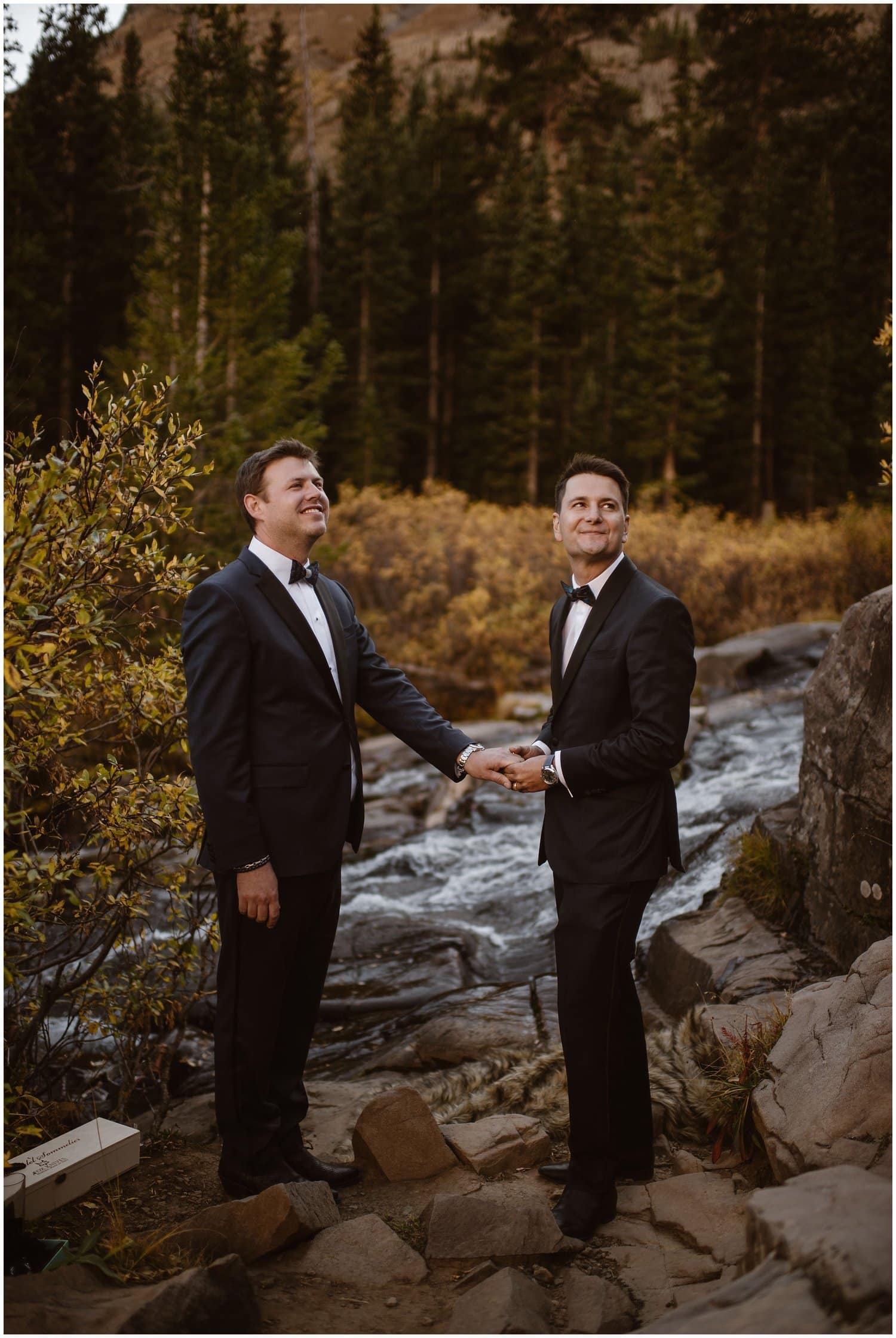 Groom holds other grooms hand during ceremony in Ouray, Colorado. 