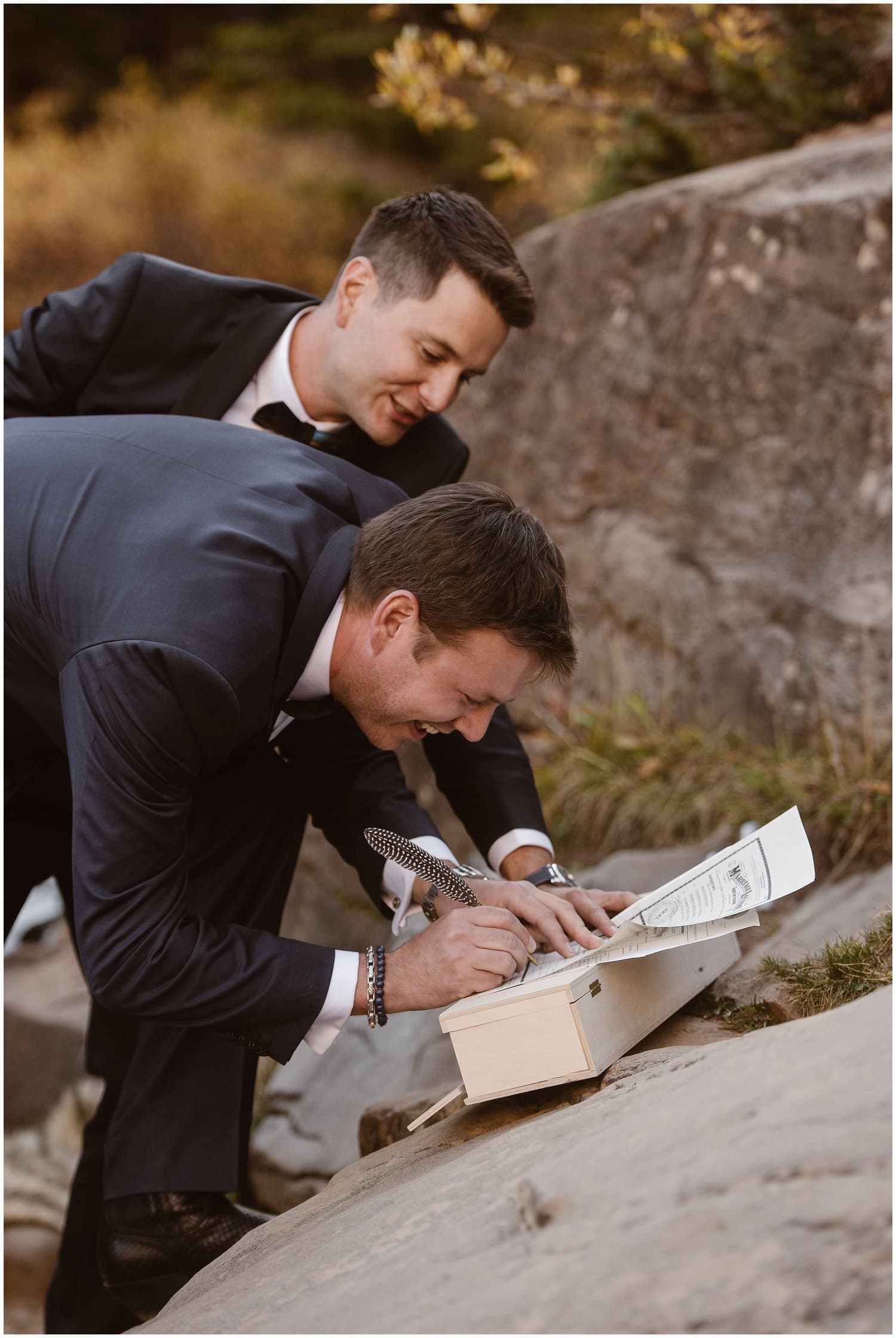 Grooms sign their marriage license together. 