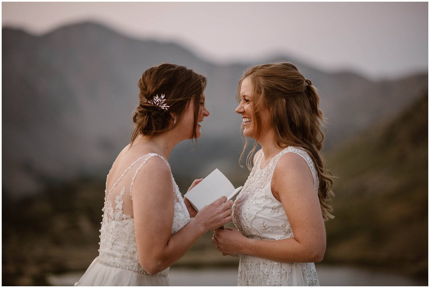 Two brides laugh while exchanging vows.