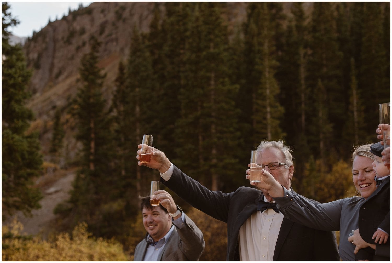 Family toasts grooms after ceremony in Ouray, Colorado. 