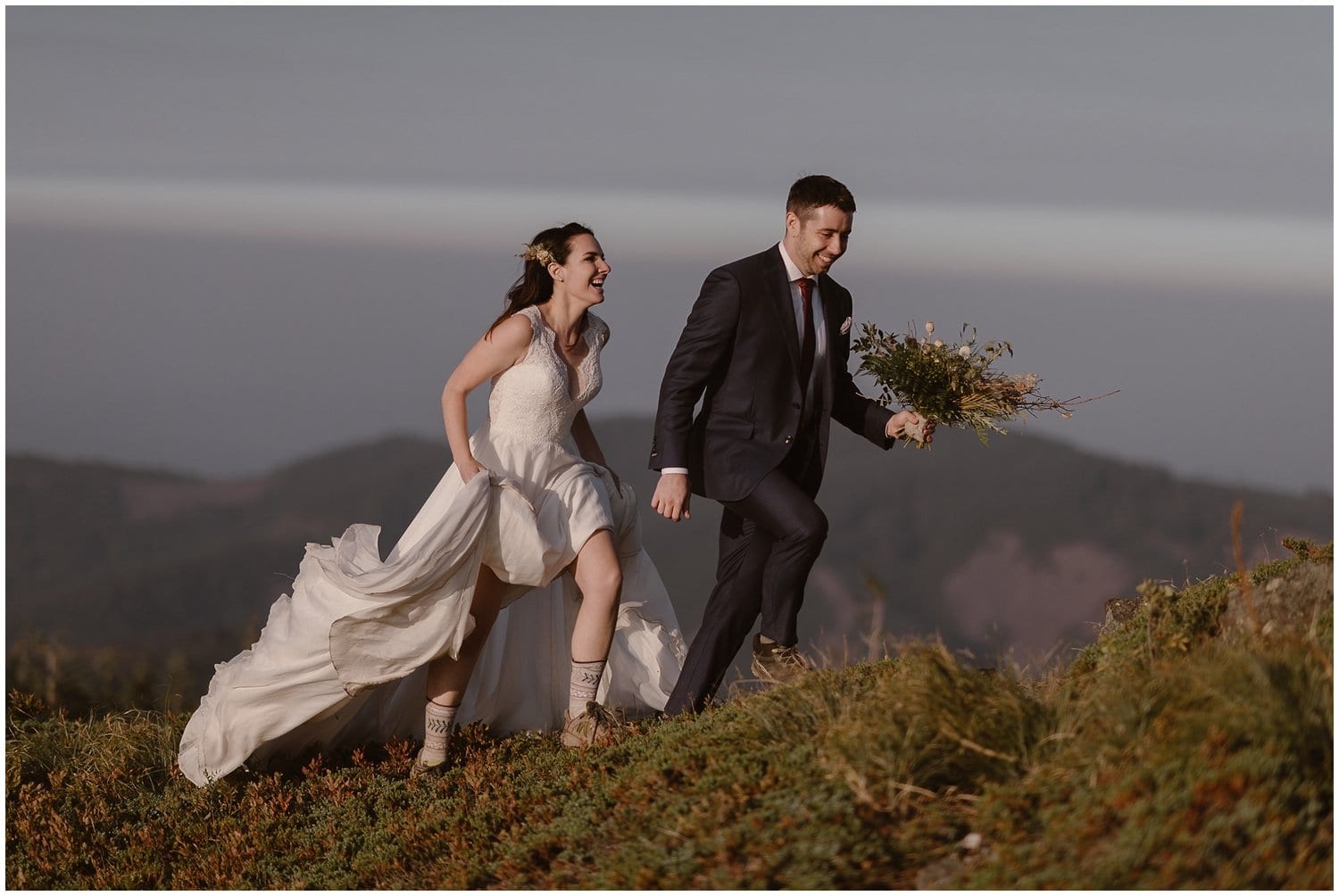 Bride and groom are hiking together during sunrise in Washington. 