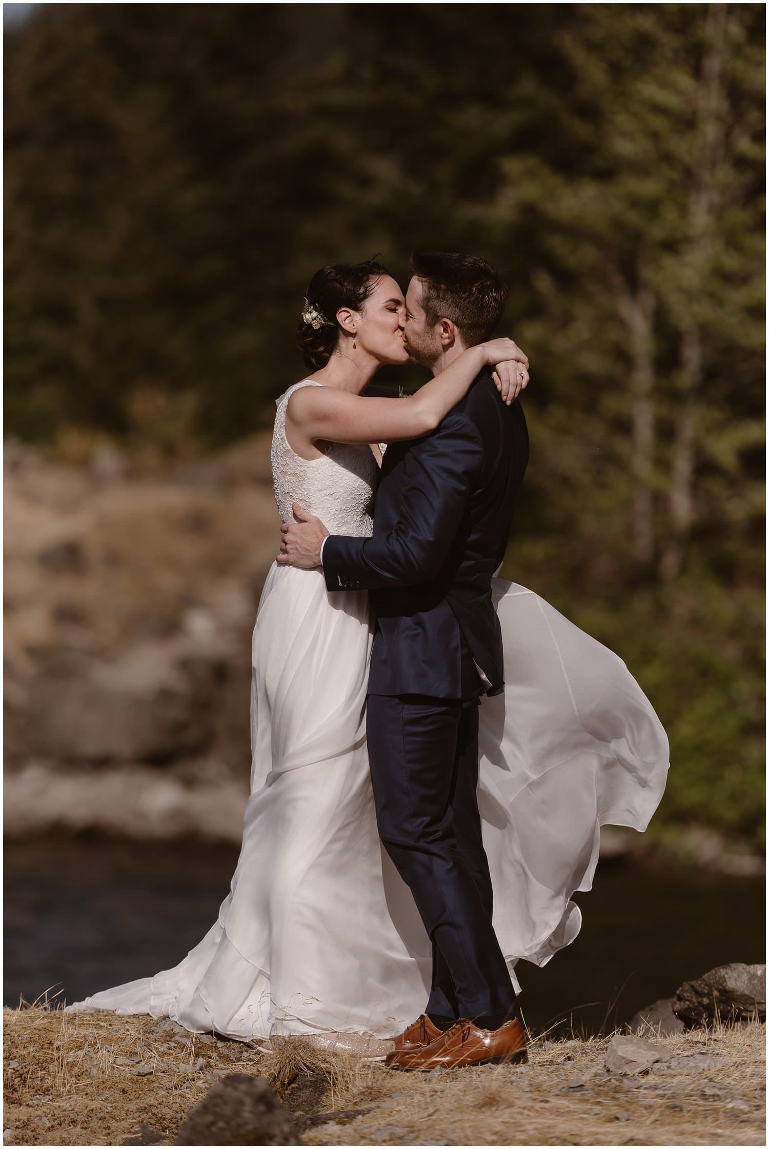 Bride and groom kiss on their elopement day at the Columbia River Gorge, in Oregon.