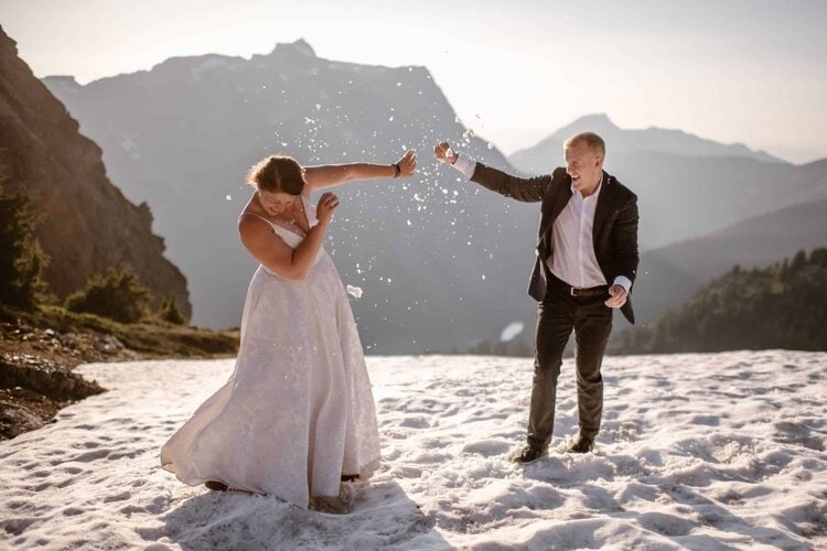 Bride and groom have a snow ball fight on their elopement day in Washington. 
