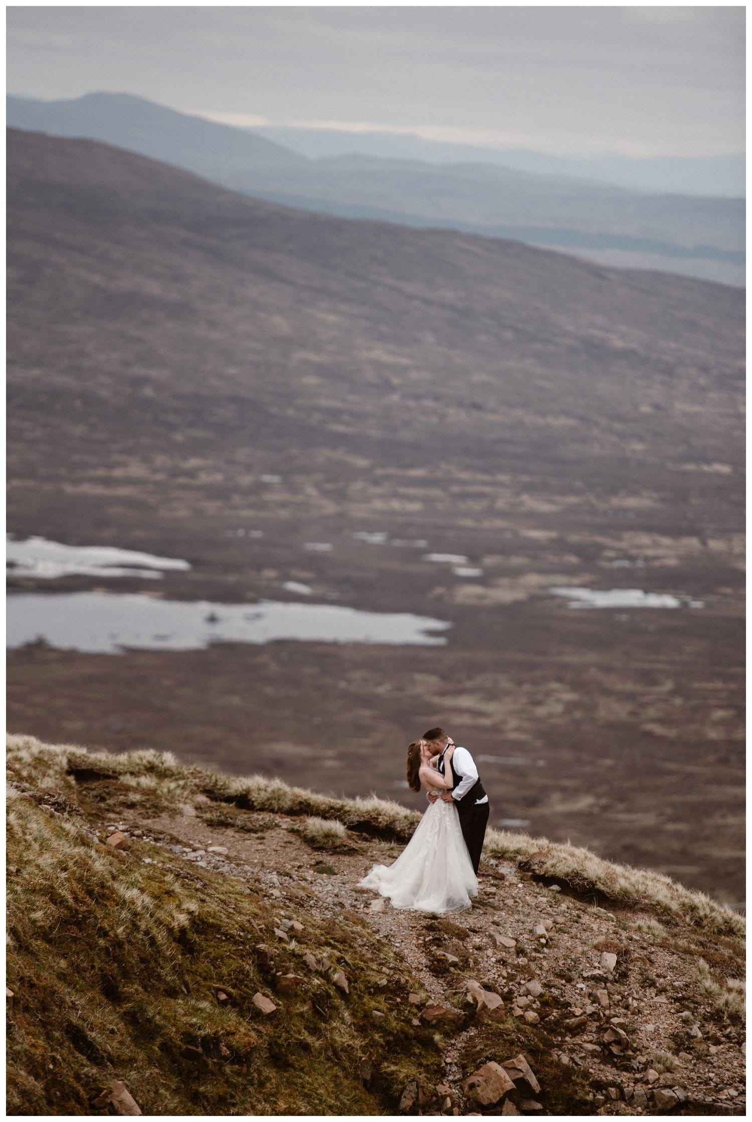 Bride and groom share a kiss in the Scottish Highlands on their elopement day.