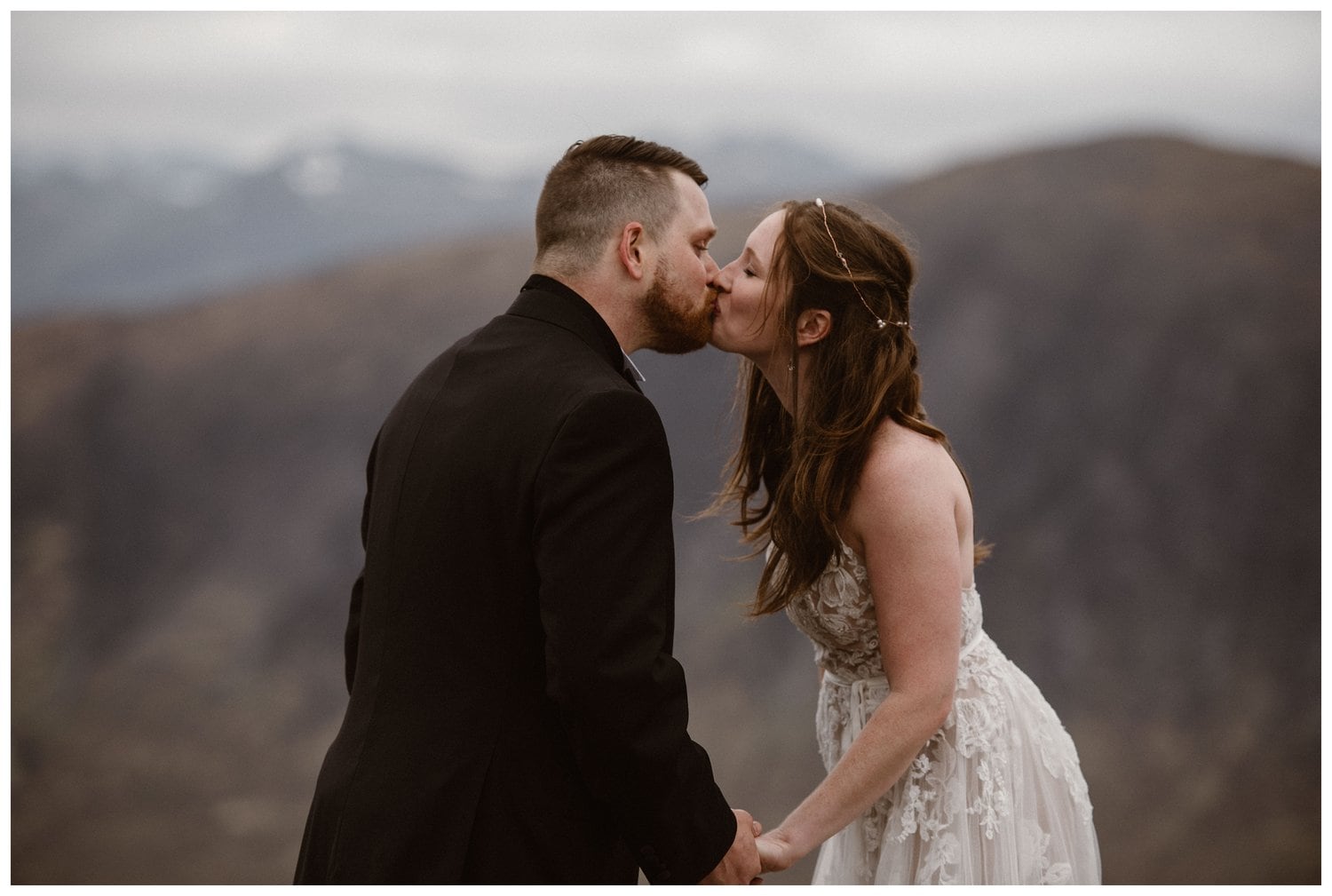 Bride and groom share a kiss during their intimate elopement ceremony in the Scottish Highlands. 