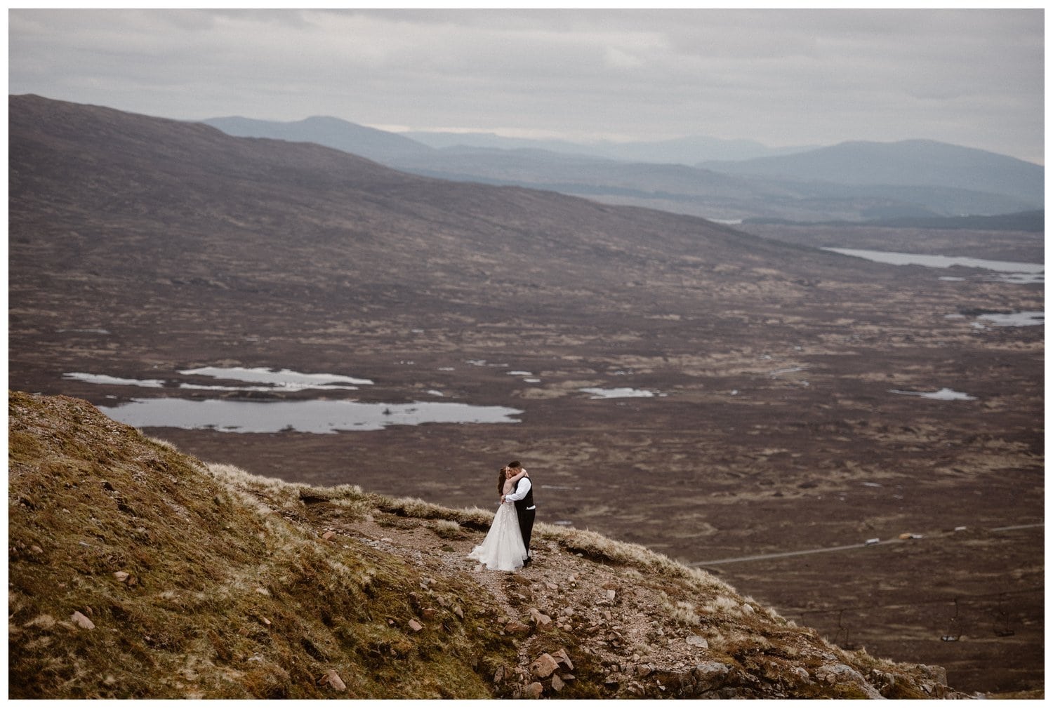 Bride and groom share a kiss on their elopement day in the Scottish Highlands. 