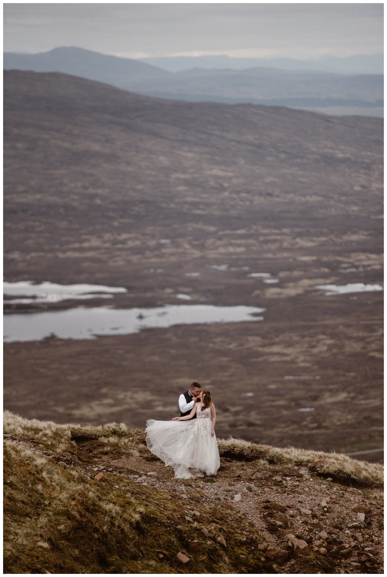 Bride and groom share a kiss on their elopement day in the Scottish Highlands.