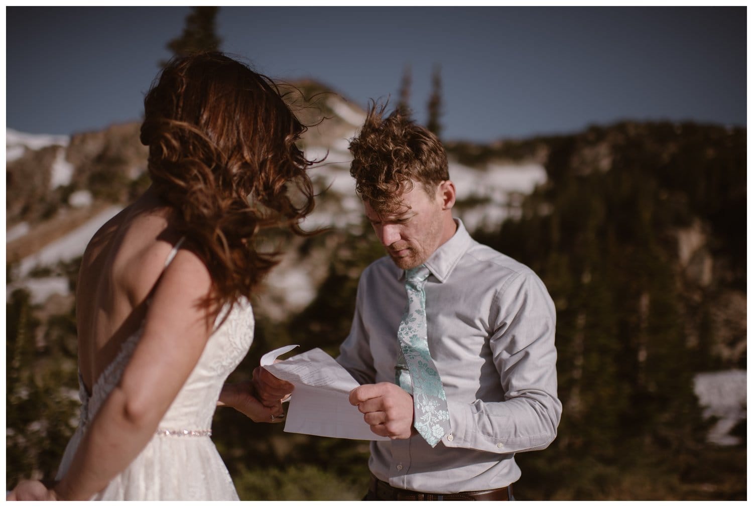 Groom reads his vows during intimate elopement ceremony at the Indian Peaks in Colorado. 
