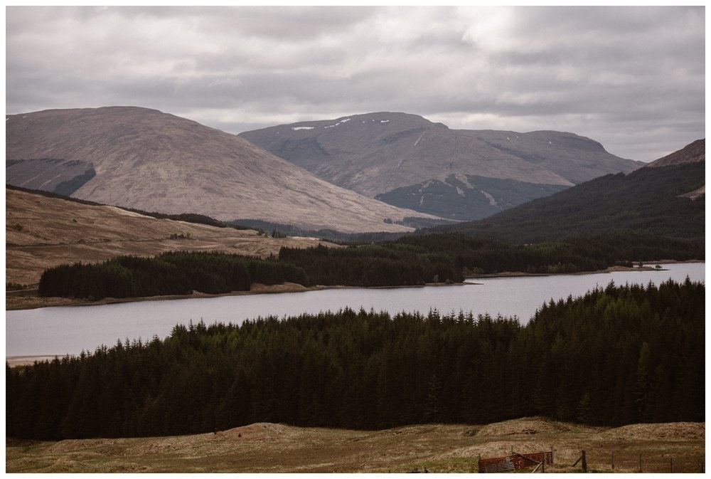 Landscape of lake, forest, and mountains in the Scottish Highlands. 