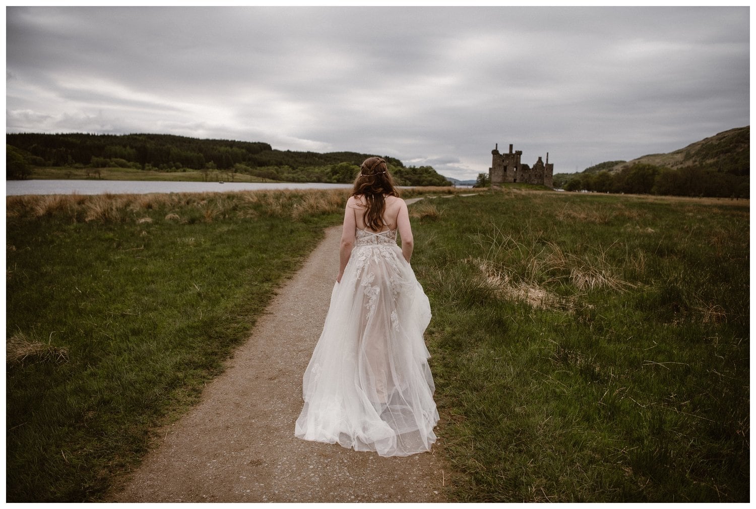 Bride walking on trail towards Kilchurn Castle in the Scottish Highlands. 